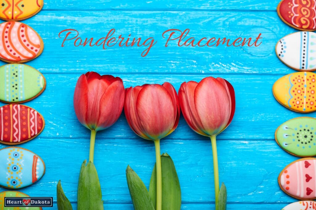 Red tulips against a bright blue wooden background. On either side, multicolored Easter egg cookies form a border.